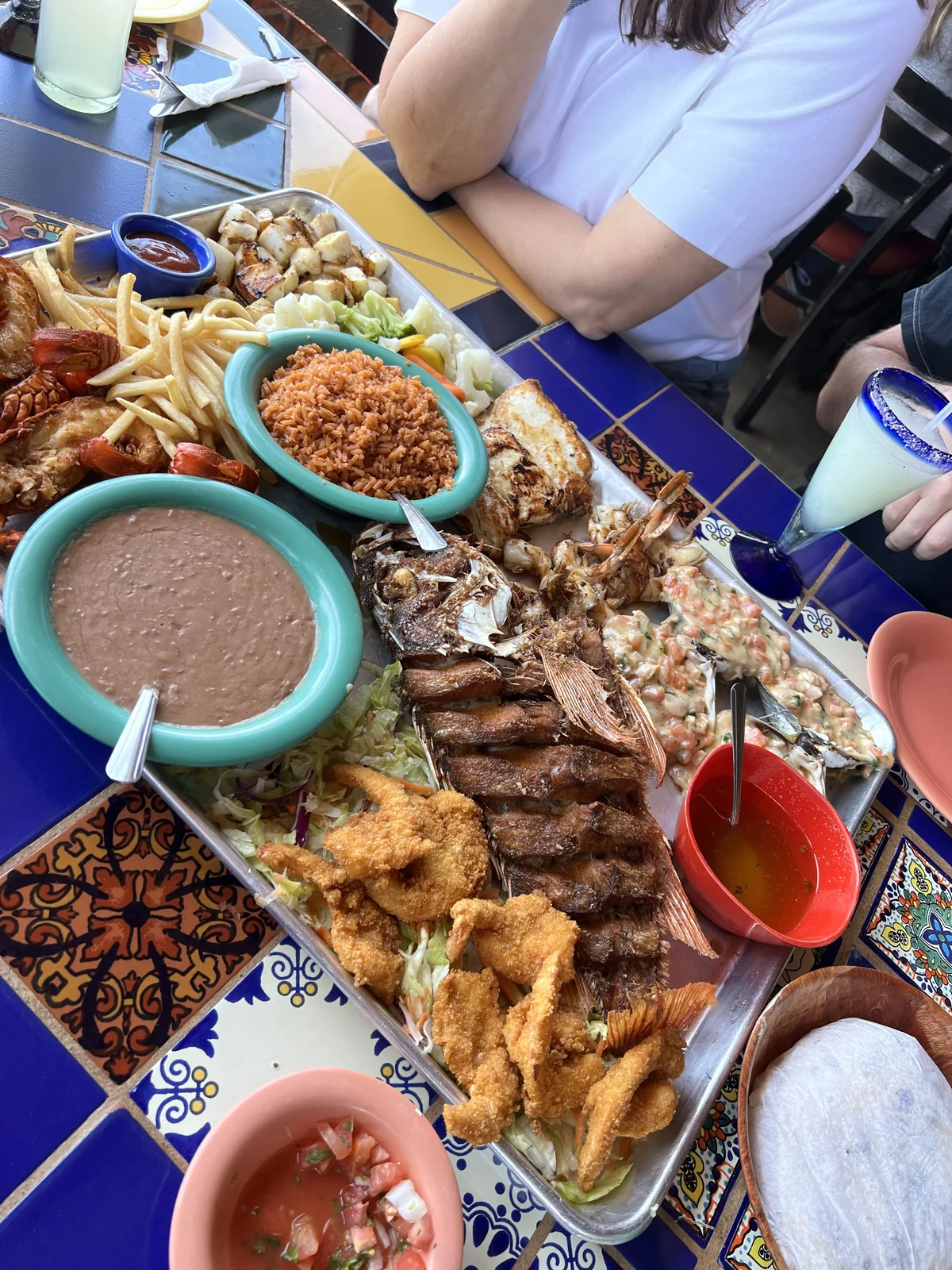 Traditional Puerto Nuevo lobster platter with beans, rice, and tortillas