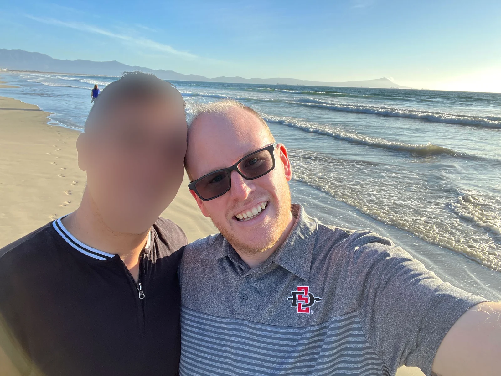 Michael and his then-husband at a Baja beach, both grinning — the early chapter when everything was still good
