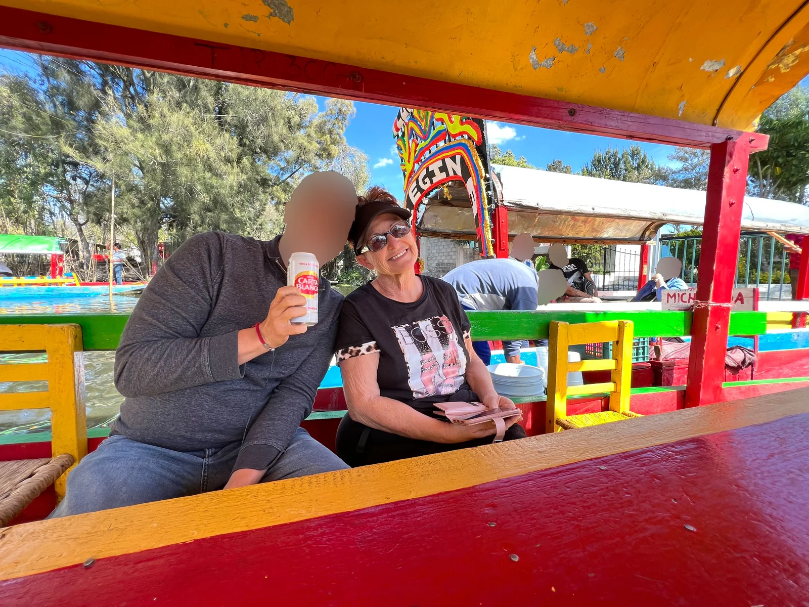 On a trajinera at Xochimilco in Mexico City — a weekend trip from the happy chapter, him and my mom, Carta Blanca in hand